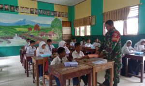 Babinsa Koramil 1315-02/Limoboto Serda Ulis Sangngaji bersama Koptu Munawir melaksanakan pendampingan pendistribusian Makan Bergizi Gratis (MBG).