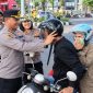 Polres Bitung membagikan helm gratis dan sembako kepada masyarakat pengguna jalan di Kawasan Tertib Lalu Lintas (KTL), tepatnya di depan Mapolsek Maesa, Jumat (18/9/2026).